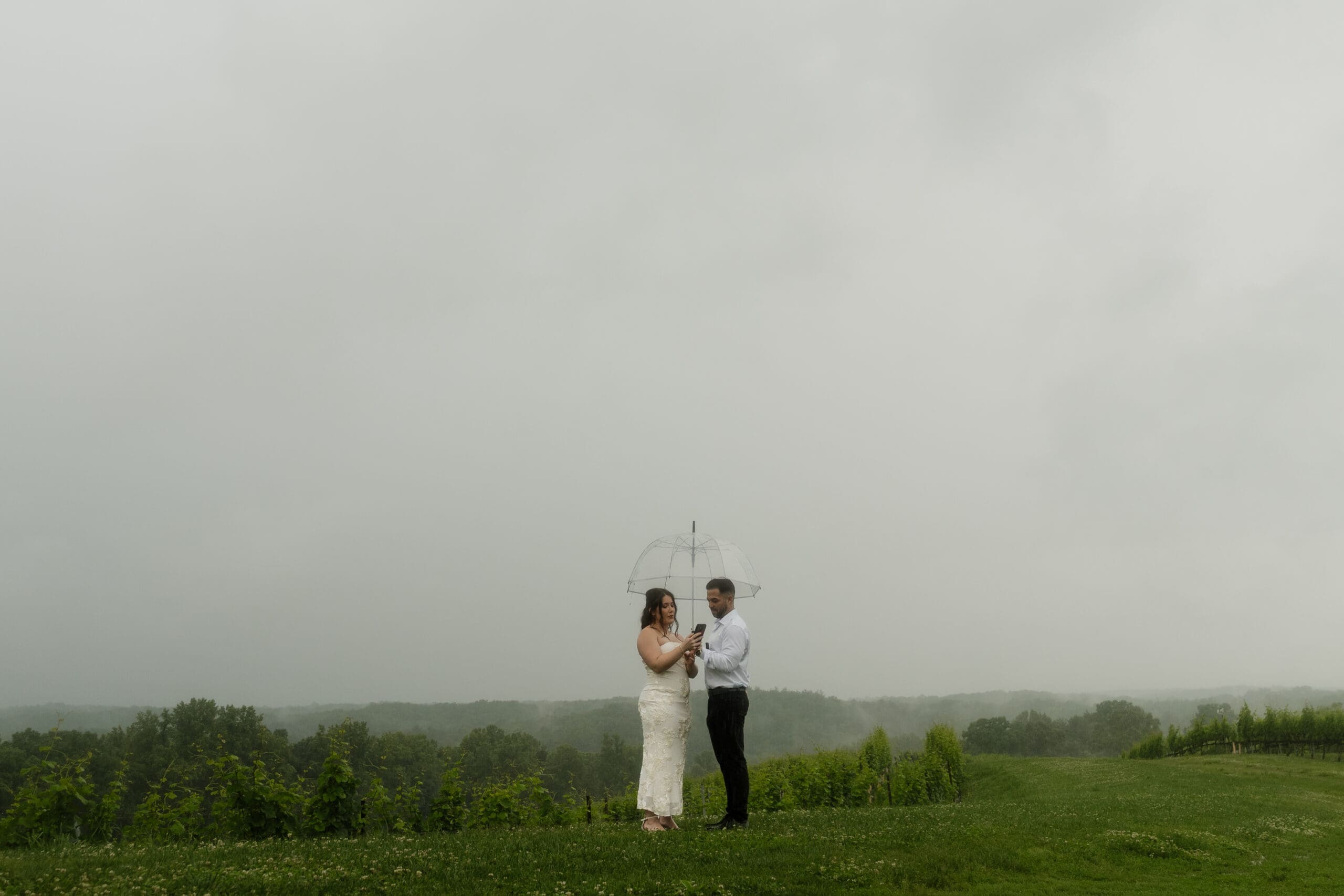Mountain wedding bride and groom in rain, captured by Crimson Conure Photography in Denver, Colorado